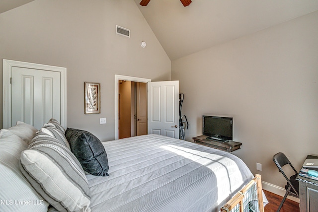 bedroom featuring ceiling fan, hardwood / wood-style floors, and high vaulted ceiling