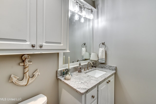 bathroom featuring toilet and vanity