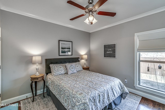 bedroom featuring ceiling fan, ornamental molding, and dark hardwood / wood-style floors