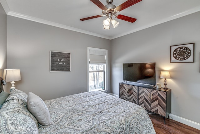 bedroom featuring dark wood-type flooring, ceiling fan, and ornamental molding