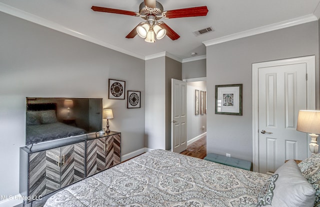 bedroom featuring ceiling fan, wood-type flooring, and ornamental molding