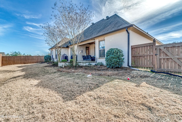 back of house with a patio and a yard