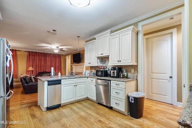 4788 Bon Jour Ln, Nesbit, MS 38651 - kitchen with stainless steel appliances, open floor plan, a peninsula, decorative backsplash, and white cabinets