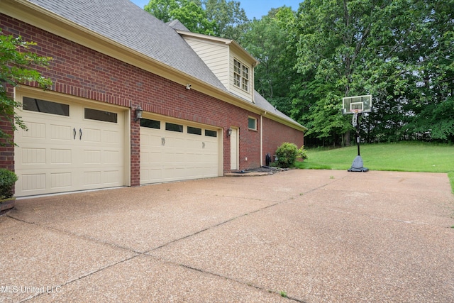 4788 Bon Jour Ln, Nesbit, MS 38651 - view of home's exterior featuring concrete driveway, roof with shingles, brick siding, a lawn, and an attached garage