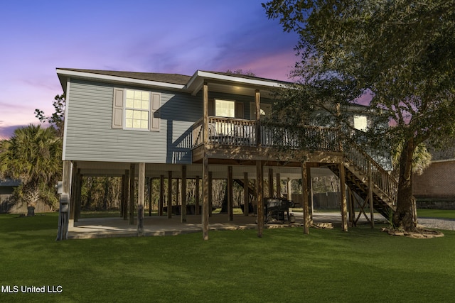 back of property with a patio area, stairs, and a lawn