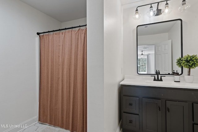 bathroom with vanity and baseboards