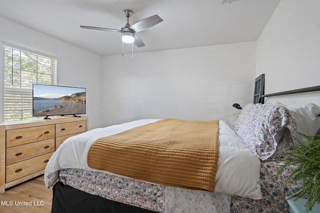 bedroom with ceiling fan and light wood-style floors