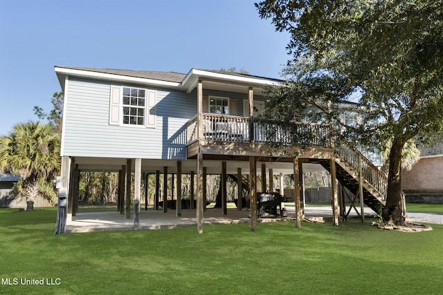 rear view of property with a patio area, a lawn, and stairs