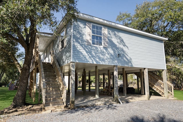 exterior space featuring a carport, a patio, and stairway