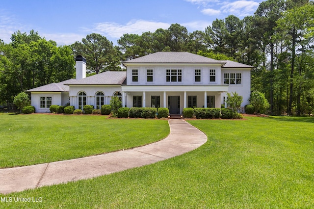 268 Sundial Rd, Madison, MS 39110 - neoclassical home featuring a chimney, stucco siding, and a front yard