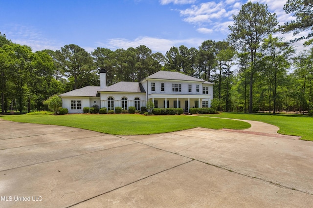 268 Sundial Rd, Madison, MS 39110 - view of front facade with a chimney, a front lawn, and view of scattered trees