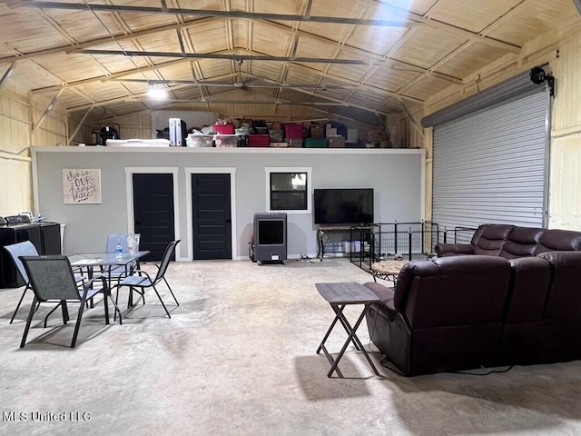 living room with lofted ceiling and concrete flooring