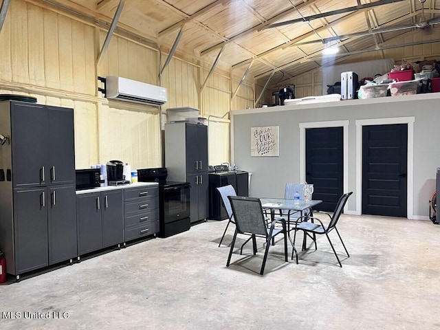 interior space with lofted ceiling, concrete flooring, and an AC wall unit