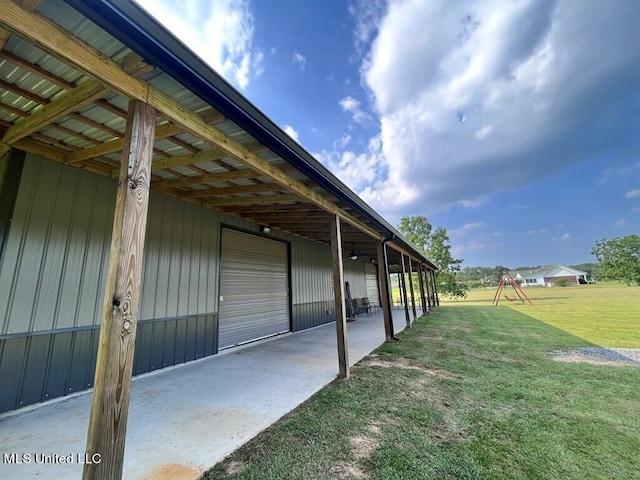 view of patio with an outdoor structure and a garage