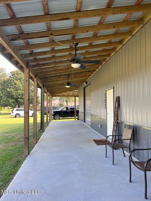 view of patio with a carport and ceiling fan