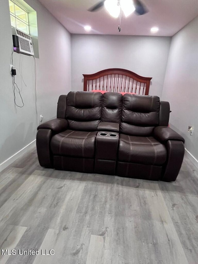 home theater featuring ceiling fan and light wood-type flooring