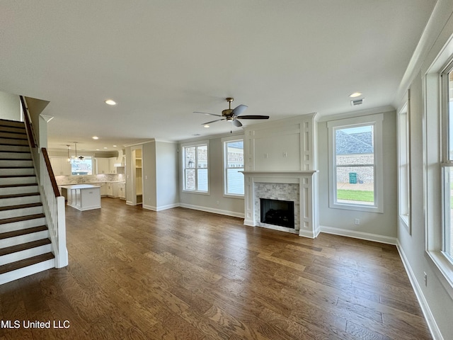 unfurnished living room featuring dark hardwood / wood-style floors and ceiling fan