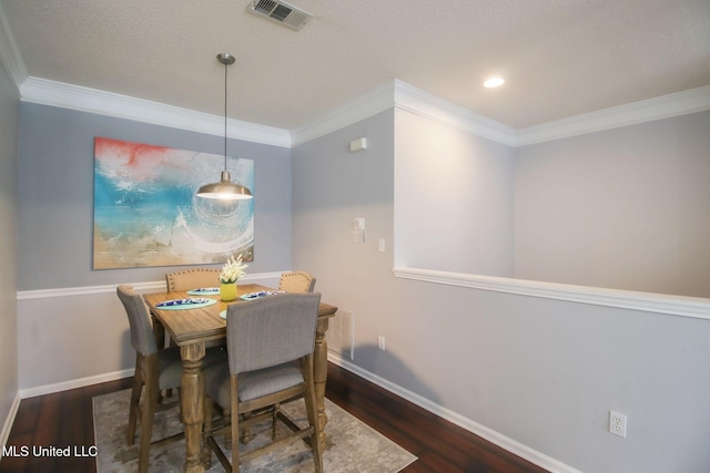 dining space featuring dark wood-type flooring and ornamental molding