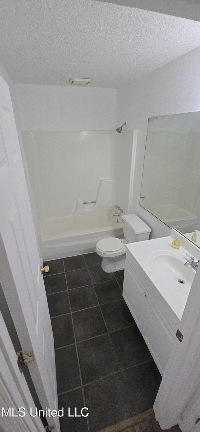 245 Mcdonnell Ave Unit D-226, Biloxi, MS 39531 - bathroom with a textured ceiling, shower / bath combination, toilet, vanity, and tile patterned floors