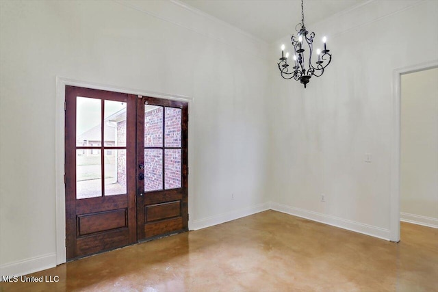 foyer entrance featuring an inviting chandelier, concrete flooring, and french doors