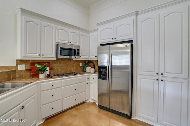 kitchen with decorative backsplash, stainless steel appliances, and white cabinetry