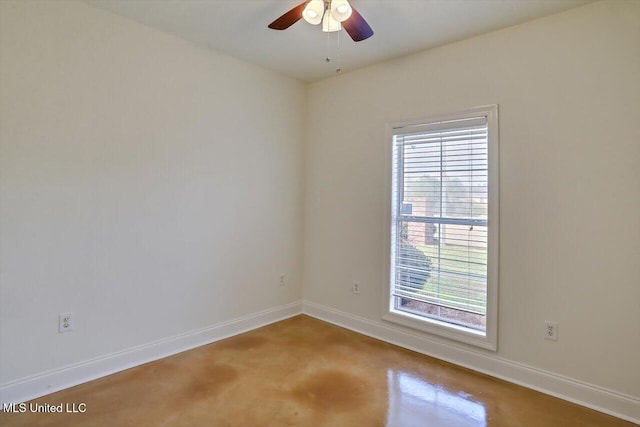 spare room featuring concrete floors and ceiling fan