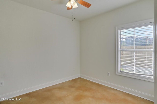 carpeted empty room featuring ceiling fan and plenty of natural light