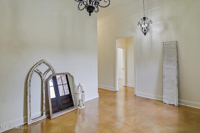 foyer entrance with concrete floors and an inviting chandelier