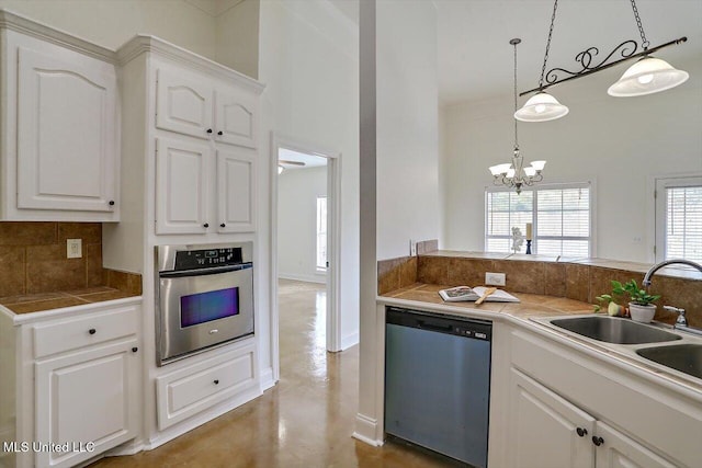 kitchen with pendant lighting, plenty of natural light, white cabinetry, and stainless steel appliances