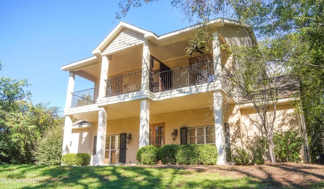 rear view of property featuring a lawn