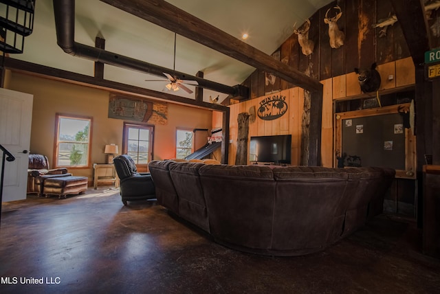 living area featuring ceiling fan, beamed ceiling, finished concrete flooring, wood walls, and high vaulted ceiling