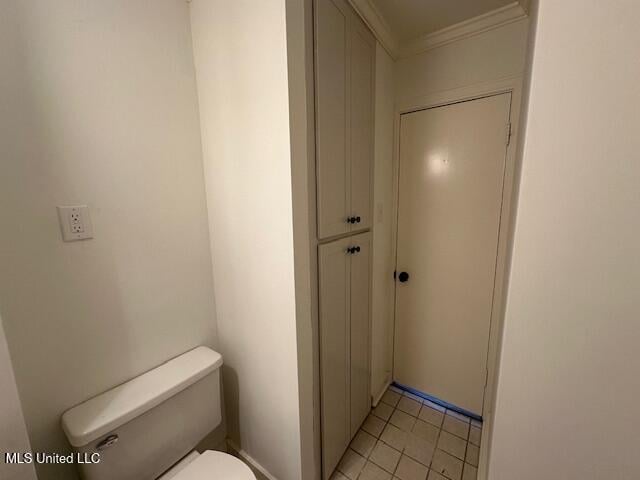 bathroom with ornamental molding and toilet