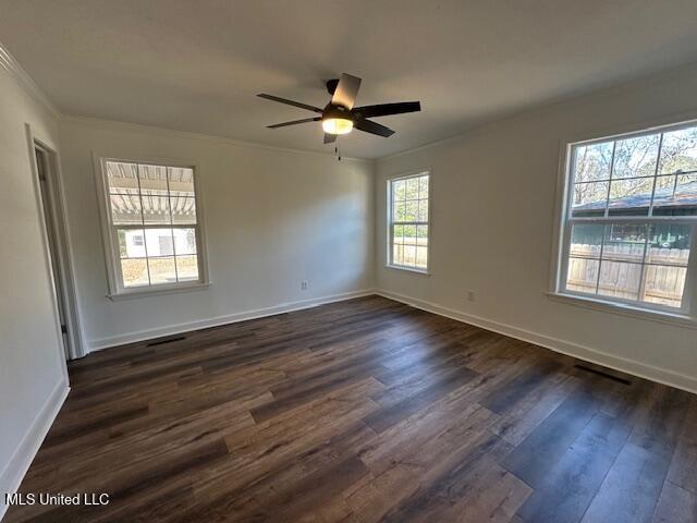 unfurnished room with ornamental molding, dark wood-type flooring, and ceiling fan