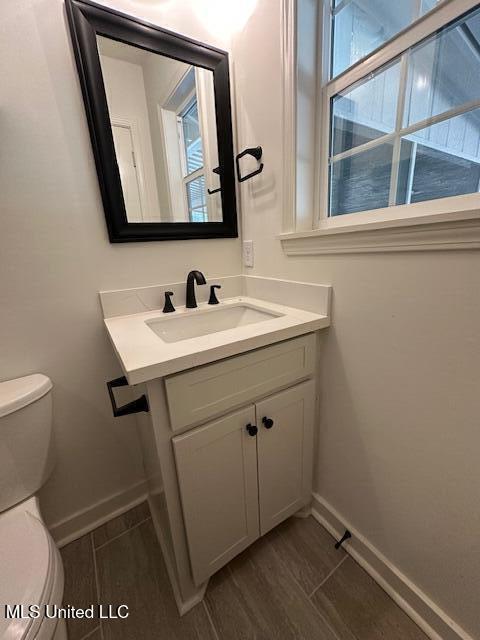 bathroom featuring vanity and toilet