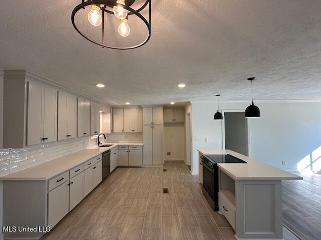 kitchen featuring sink, hanging light fixtures, stainless steel dishwasher, black range with electric stovetop, and decorative backsplash