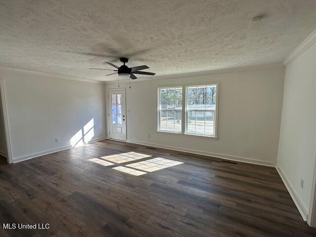 empty room featuring ornamental molding, ceiling fan, a textured ceiling, and dark hardwood / wood-style flooring