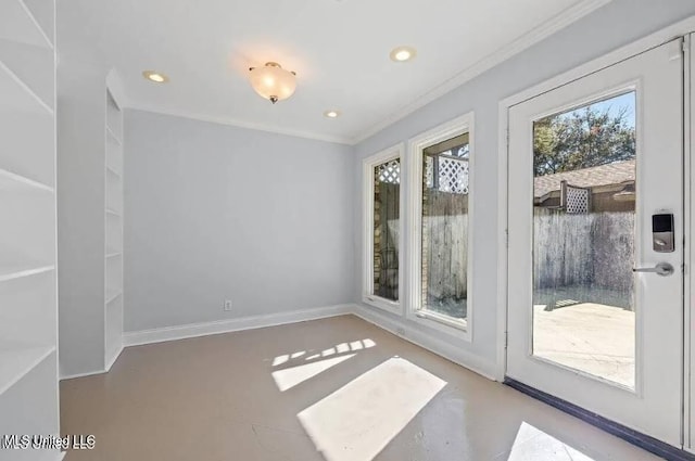 spare room with concrete floors and crown molding