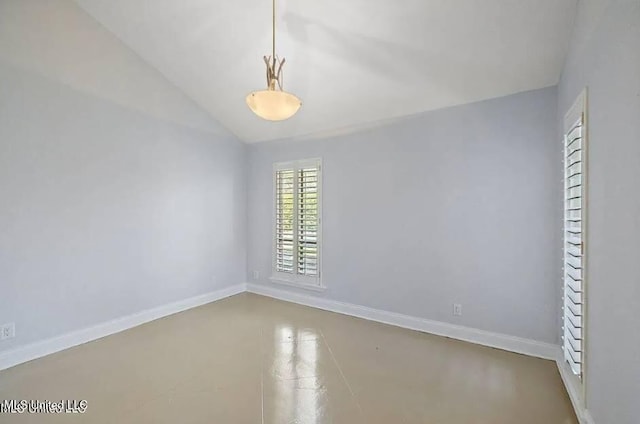 empty room featuring lofted ceiling