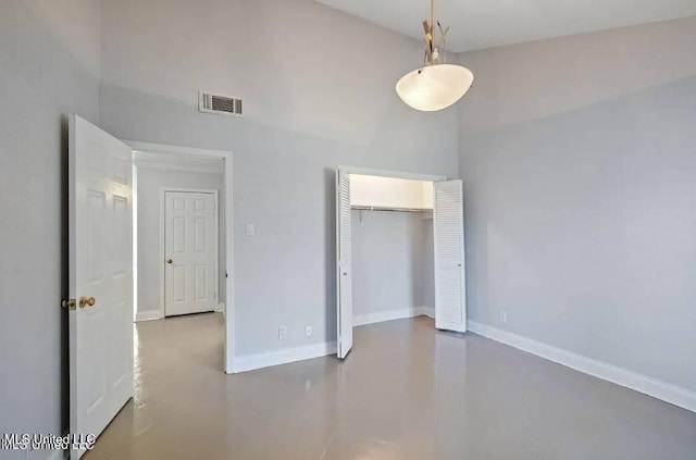 unfurnished bedroom featuring a closet and concrete flooring