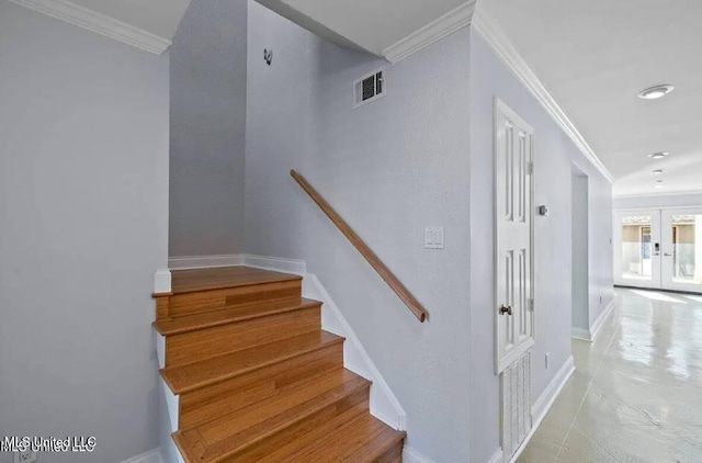 stairway with french doors, tile patterned floors, and crown molding