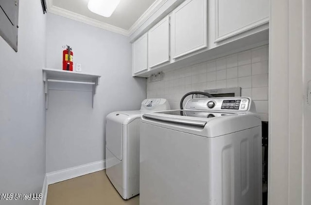 laundry room with cabinets, washer and dryer, and crown molding