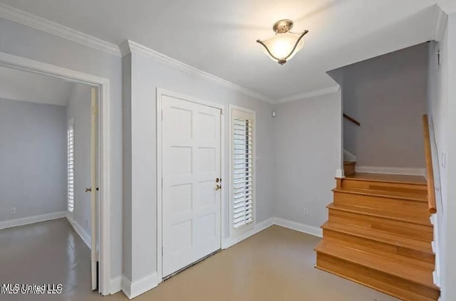 foyer entrance with ornamental molding and concrete flooring