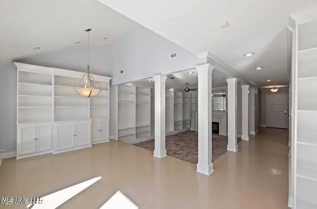 interior space with ceiling fan, built in shelves, and decorative columns