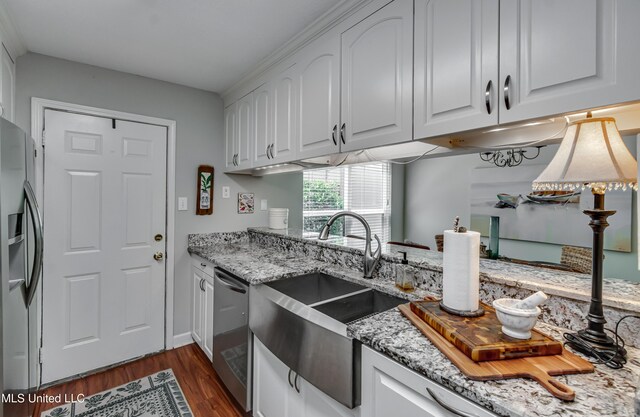 550 Post Rd Unit 116, Ridgeland, MS 39157 - kitchen featuring appliances with stainless steel finishes, white cabinetry, light stone countertops, and dark wood-style floors