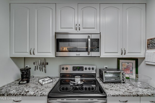 550 Post Rd Unit 116, Ridgeland, MS 39157 - kitchen featuring stainless steel appliances, white cabinets, and light stone countertops