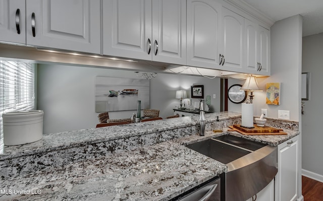 550 Post Rd Unit 116, Ridgeland, MS 39157 - kitchen with light stone countertops, white cabinets, and dark wood finished floors