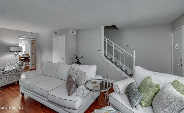 550 Post Rd Unit 116, Ridgeland, MS 39157 - living room featuring wood finished floors, stairs, and a textured ceiling