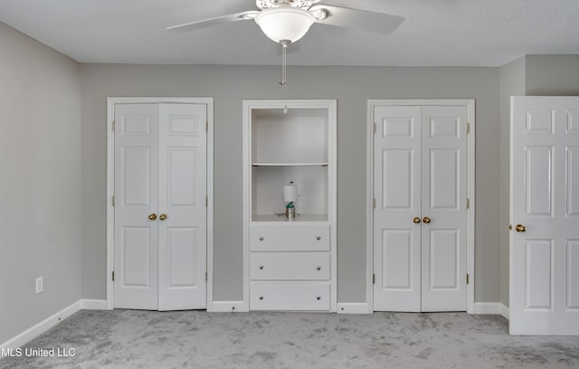 550 Post Rd Unit 116, Ridgeland, MS 39157 - unfurnished bedroom featuring carpet flooring, two closets, and a ceiling fan
