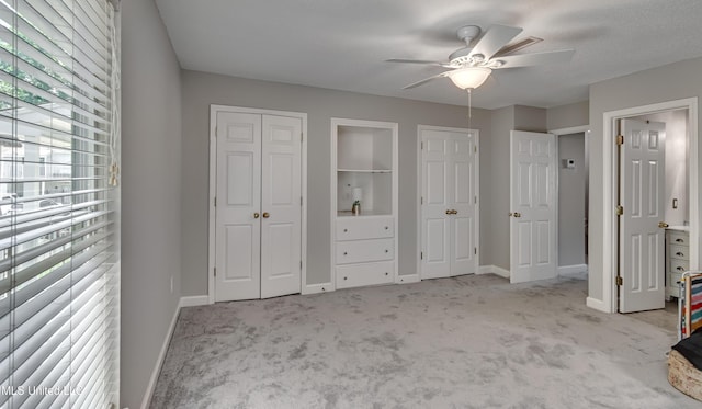 550 Post Rd Unit 116, Ridgeland, MS 39157 - unfurnished bedroom with multiple windows, carpet, multiple closets, and a ceiling fan