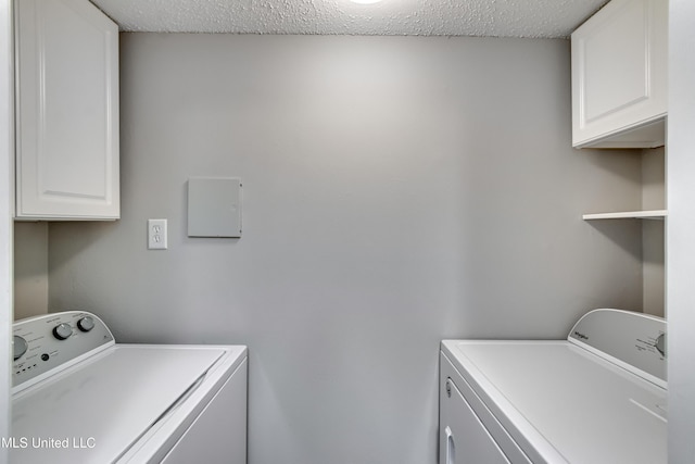 550 Post Rd Unit 116, Ridgeland, MS 39157 - laundry area with washing machine and clothes dryer, cabinet space, and a textured ceiling